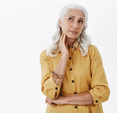 dreamy-pretty-senior-woman-looking-upper-left-corner-thoughtful