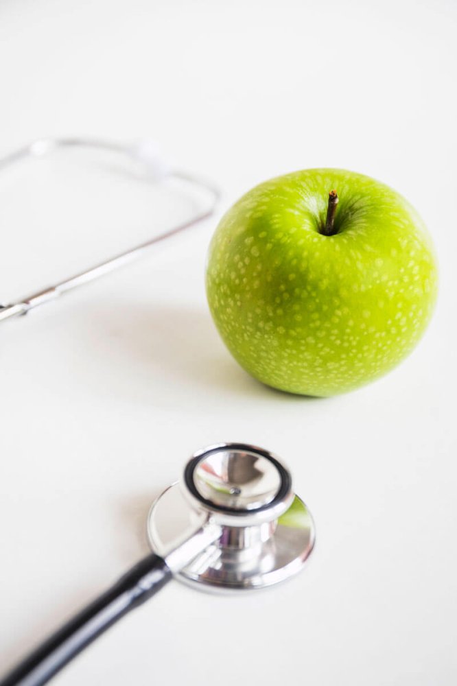 green-apple-stethoscope-white-background